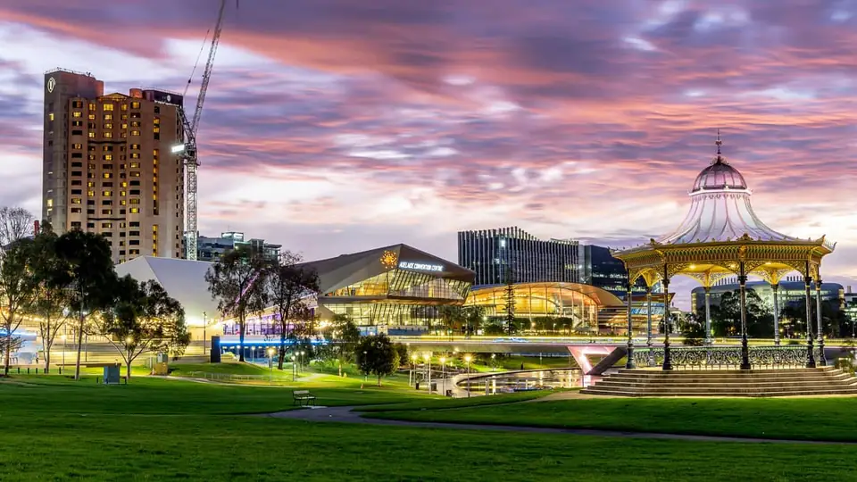 Adelaide Convention Centre and Elder Park rotunda lit up at dusk