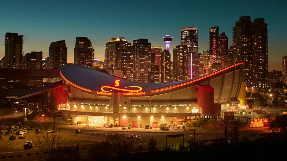 The Scotiabank Saddledome and Calgary skyline at dusk