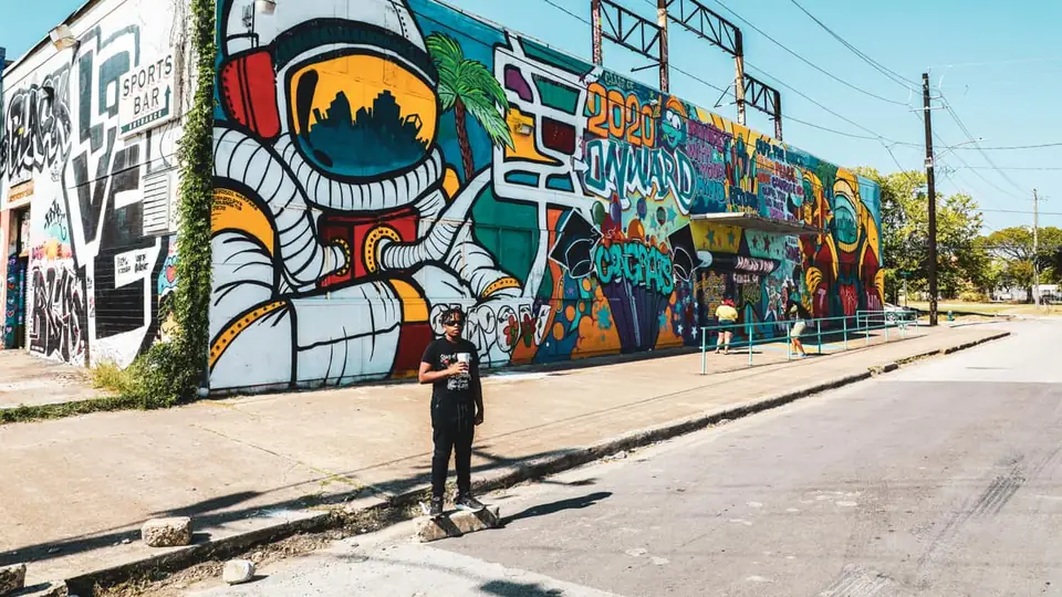A colourful astronaut street mural in Houston with the skyline in the visor