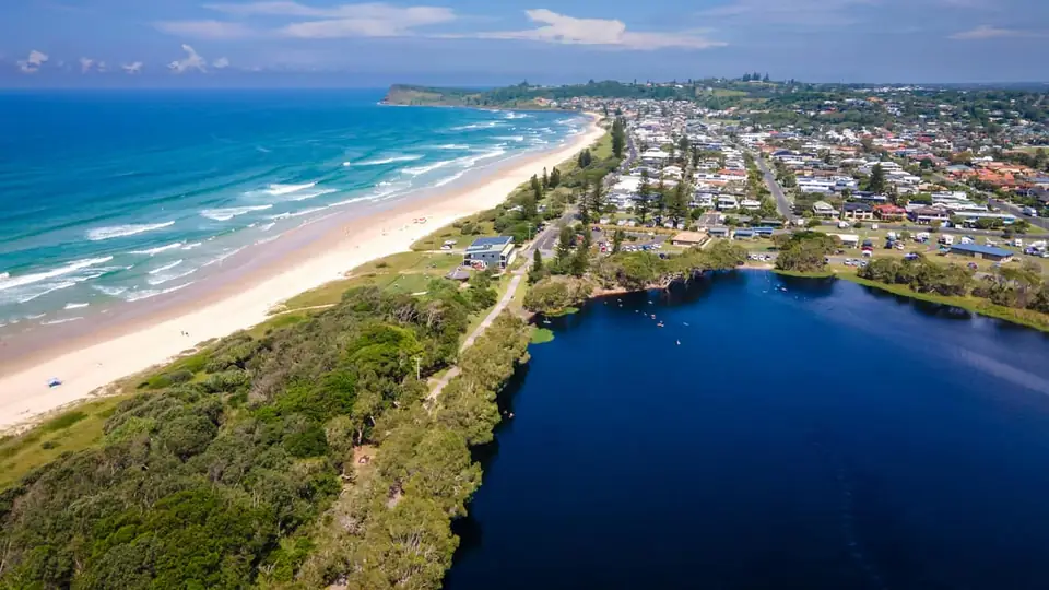 Aerial view of a Sunshine Coast beach town beside a lagoon