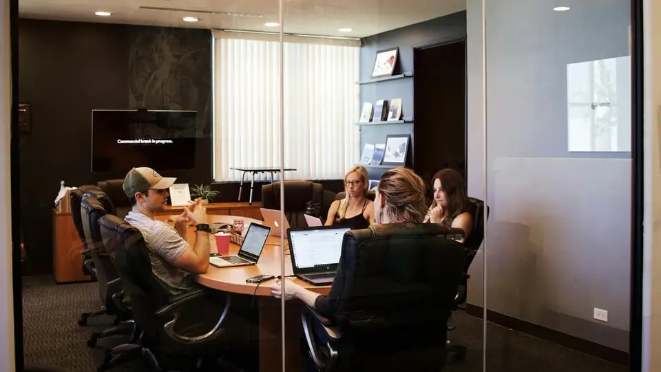 Professionals meeting around a table in an office boardroom