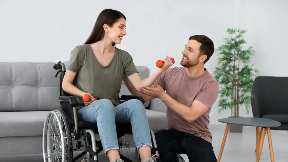 A physiotherapist guiding a client through a dumbbell exercise